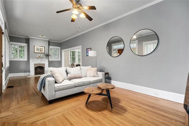 13 Demouy Ave, Mobile, AL 36606 - living room featuring baseboards, plenty of natural light, light wood-style flooring, crown molding, and a ceiling fan