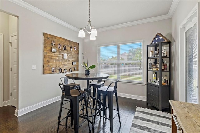 dining room featuring a notable chandelier, dark hardwood / wood-style flooring, and crown molding