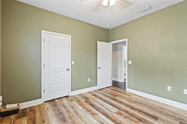 unfurnished bedroom featuring light wood-type flooring and ceiling fan