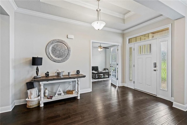 entryway with dark wood-type flooring, ceiling fan, a raised ceiling, and crown molding