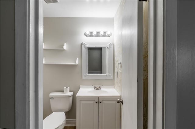 bathroom with toilet and vanity