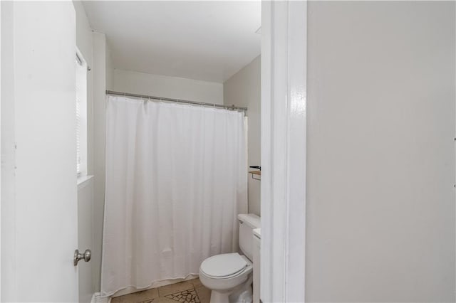 full bathroom with tile patterned flooring, toilet, and a shower with shower curtain