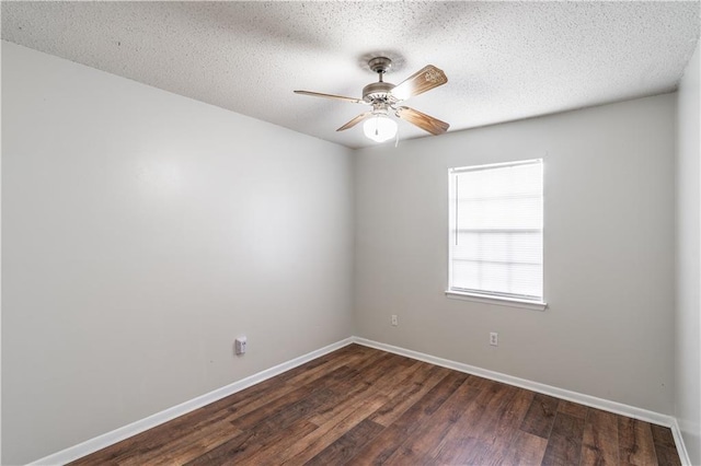 unfurnished room with baseboards, a ceiling fan, wood finished floors, and a textured ceiling