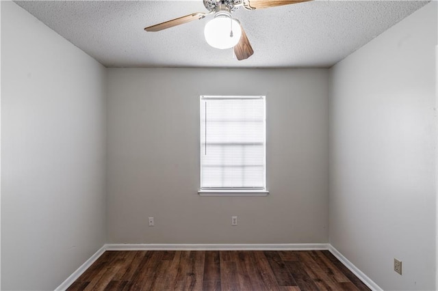 empty room featuring baseboards, a textured ceiling, dark wood-type flooring, and ceiling fan