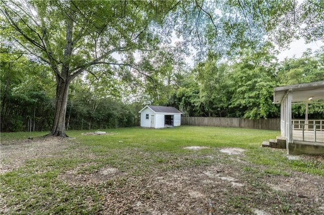 view of yard with fence and an outbuilding
