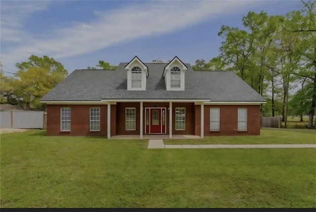 view of front of home with a front lawn and fence