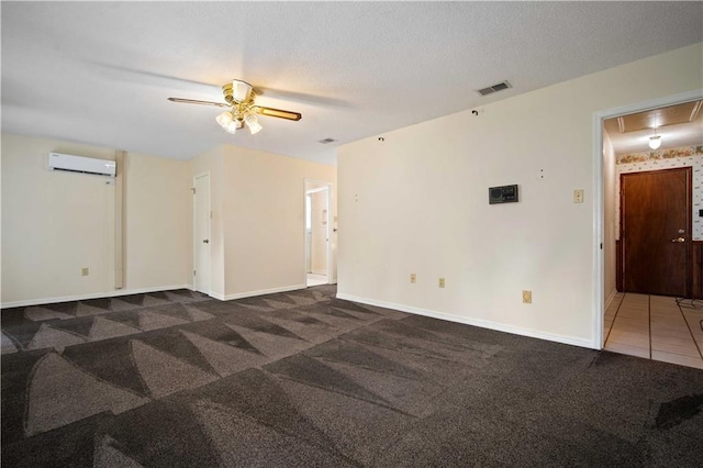 504 Vaughan Dr N, Satsuma, AL 36572 - carpeted empty room featuring an AC wall unit, attic access, ceiling fan, and baseboards