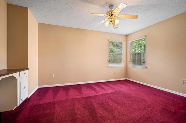 504 Vaughan Dr N, Satsuma, AL 36572 - spare room with dark colored carpet, a textured ceiling, ceiling fan, and baseboards