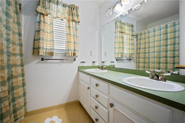 504 Vaughan Dr N, Satsuma, AL 36572 - full bath featuring double vanity, tile patterned floors, and baseboards