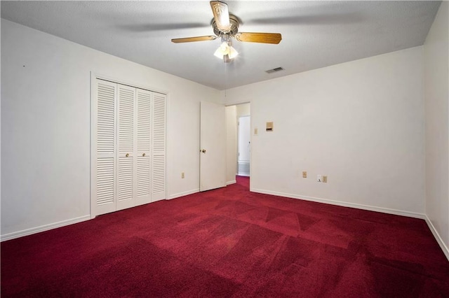 504 Vaughan Dr N, Satsuma, AL 36572 - unfurnished bedroom featuring carpet, a closet, baseboards, and a ceiling fan