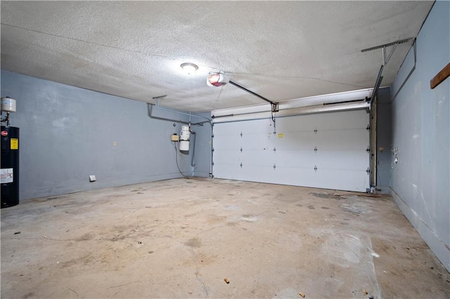 504 Vaughan Dr N, Satsuma, AL 36572 - garage featuring a garage door opener, electric water heater, and a central vacuum unit