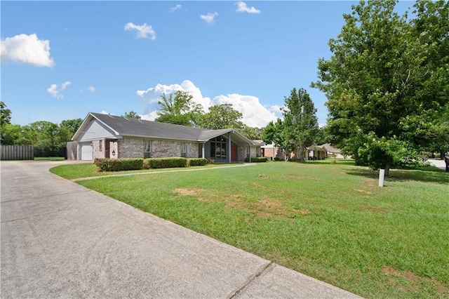 504 Vaughan Dr N, Satsuma, AL 36572 - view of front facade with a front yard, brick siding, and asphalt driveway