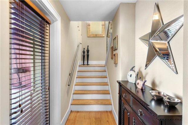 stairs featuring hardwood / wood-style flooring