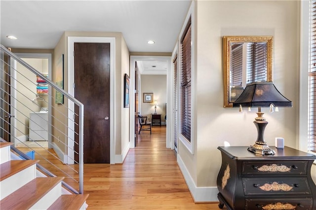 corridor featuring washer / dryer and light hardwood / wood-style floors