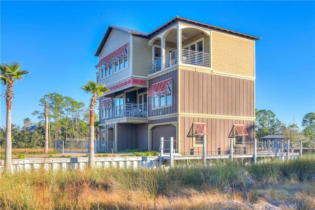 rear view of house featuring a balcony