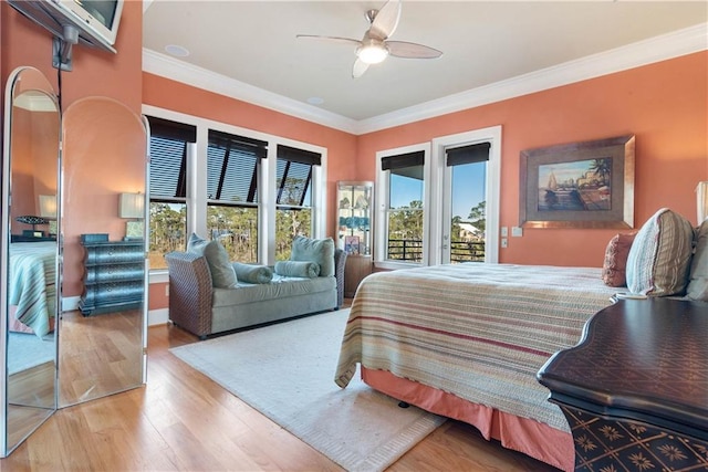 bedroom featuring light hardwood / wood-style flooring, multiple windows, access to exterior, and ceiling fan