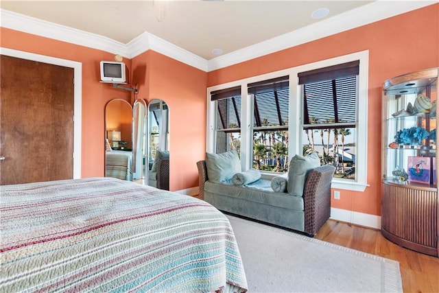 bedroom featuring ornamental molding and hardwood / wood-style floors