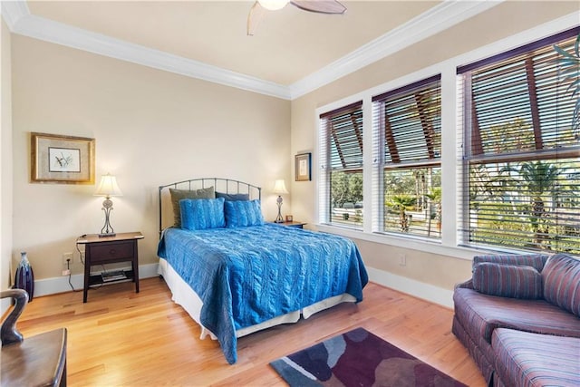 bedroom featuring ceiling fan, hardwood / wood-style floors, and crown molding