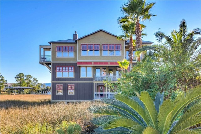 back of property with a balcony