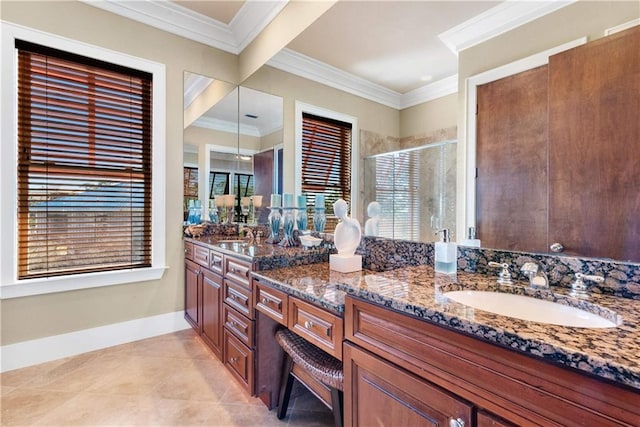 bathroom featuring walk in shower, vanity, crown molding, and tile patterned floors