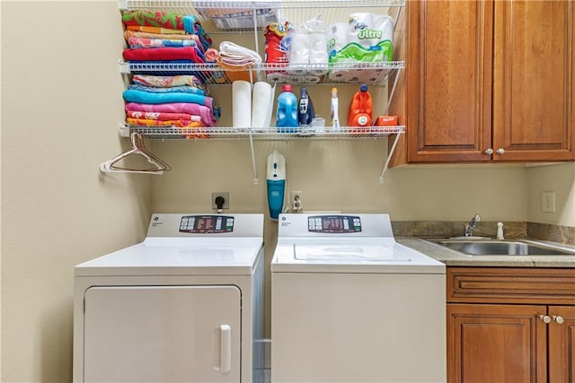 laundry area with cabinets, washer and clothes dryer, and sink