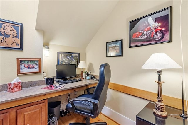 office space featuring vaulted ceiling and hardwood / wood-style floors