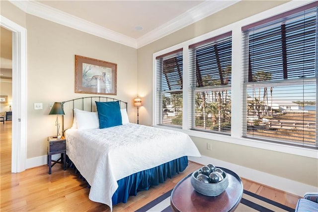 bedroom featuring crown molding and hardwood / wood-style floors