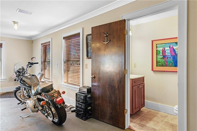 interior space featuring ornamental molding and light tile patterned floors