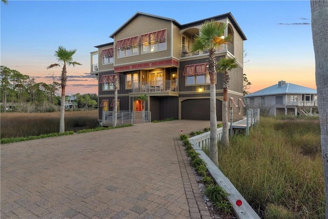 exterior space featuring a balcony and a garage