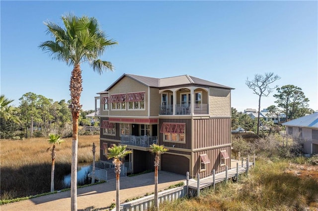 view of front of house featuring a balcony and a garage