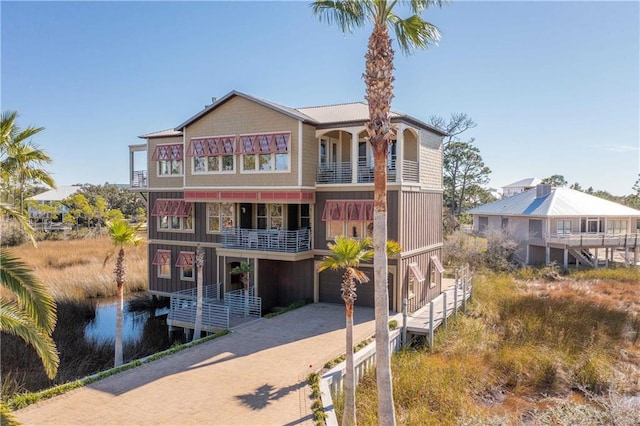 back of house featuring a balcony and a garage