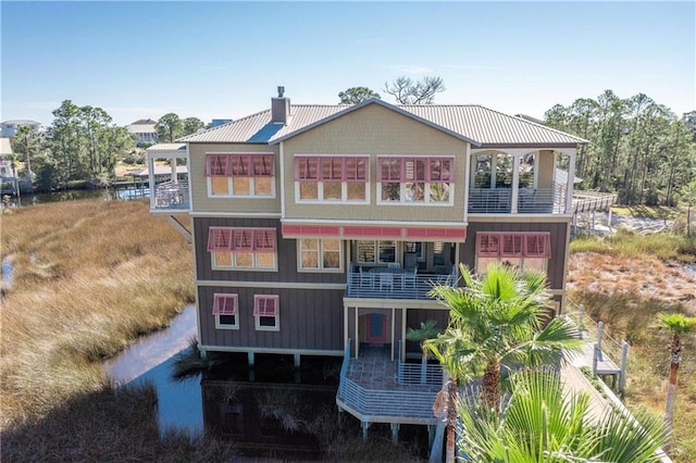 rear view of property featuring a balcony