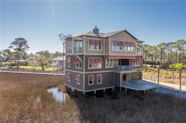 back of house featuring a balcony