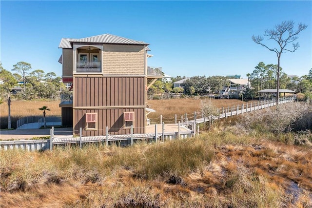 back of property with a balcony