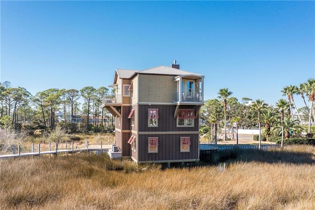 back of house featuring a balcony