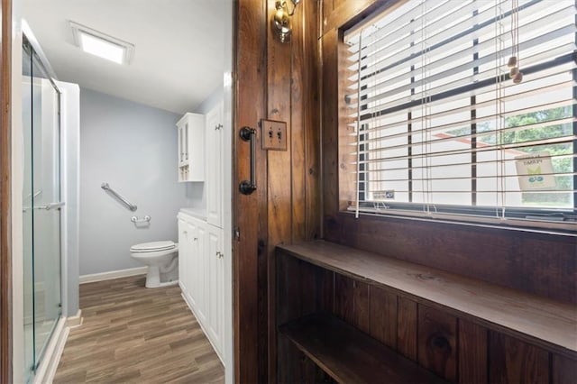 4221 Bay Front Rd, Mobile, AL 36605 - bathroom with lofted ceiling, toilet, wood finished floors, baseboards, and a shower with shower door