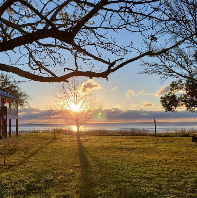 4221 Bay Front Rd, Mobile, AL 36605 - yard at dusk featuring a water view and a lawn