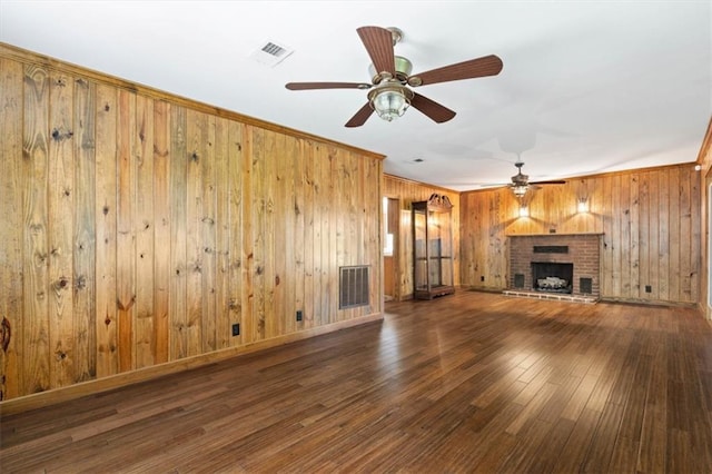 4221 Bay Front Rd, Mobile, AL 36605 - unfurnished living room with ceiling fan, wooden walls, wood-type flooring, a brick fireplace, and ornamental molding