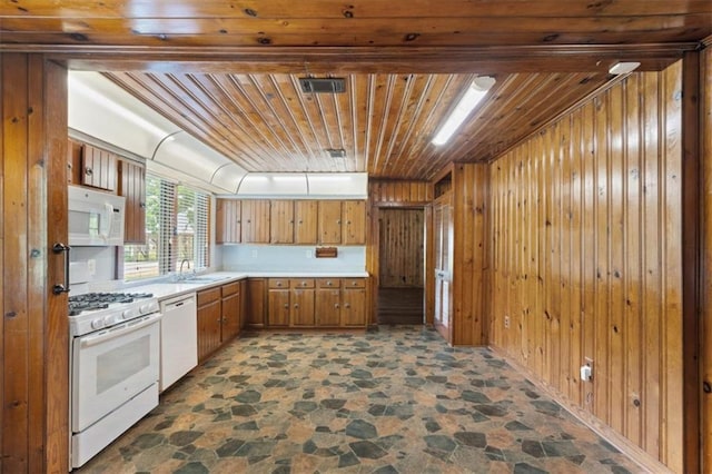 4221 Bay Front Rd, Mobile, AL 36605 - kitchen featuring white appliances, dark stone finish flooring, wood ceiling, brown cabinets, and a sink