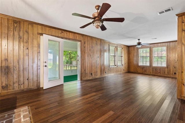 4221 Bay Front Rd, Mobile, AL 36605 - unfurnished living room featuring healthy amount of natural light, wooden walls, a ceiling fan, and dark wood-style floors