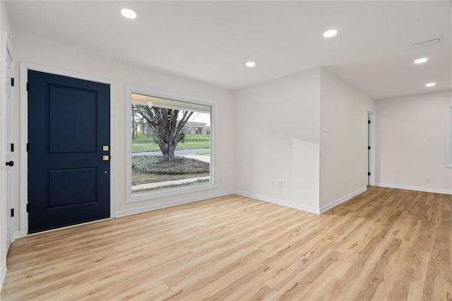 foyer entrance with light wood-style flooring, baseboards, and recessed lighting