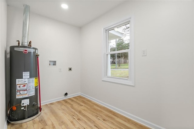 washroom featuring gas water heater, hookup for a washing machine, hookup for an electric dryer, laundry area, and baseboards