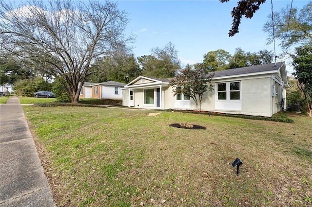 ranch-style house with a front lawn and brick siding