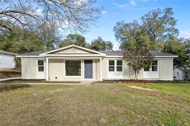 single story home with brick siding and a front yard