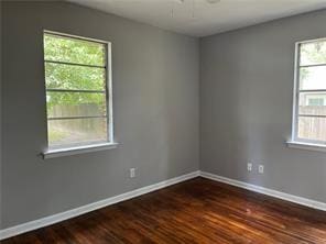 empty room featuring dark hardwood / wood-style flooring