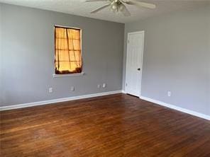 unfurnished room featuring dark hardwood / wood-style flooring and ceiling fan