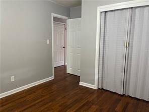 unfurnished bedroom featuring dark hardwood / wood-style floors