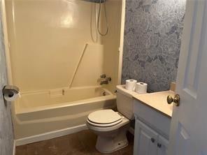 full bathroom with bathing tub / shower combination, vanity, and toilet