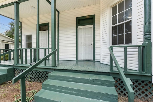 view of exterior entry featuring a porch