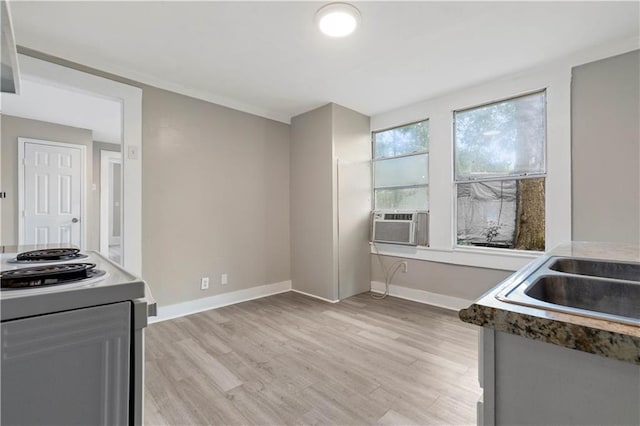 kitchen featuring light wood-type flooring, white electric range oven, sink, and cooling unit